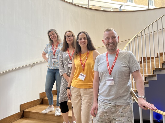 Delgegates standing on the stairs at conference: James Doherty, Natasha Hirst, Ann Galpin &  Cristina Lago
