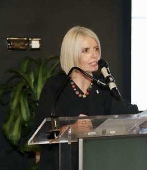 Siobhan Holliman is captured speaking at a lectern